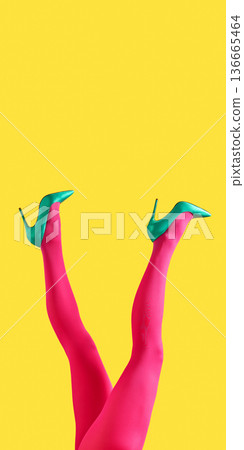 Female legs in green heels and pink tights lifted on yellow backdrop Female legs in green heels and pink tights lifted on yellow backdrop 136665464