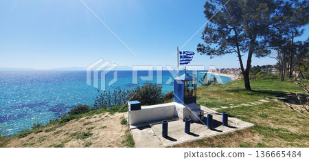 A small chapel with a cross and a fluttering Greek flag A small chapel with a cross and a fluttering Greek flag 136665484
