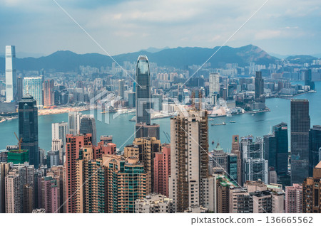 HONG KONG CHINA - DECEMBER 29 2025: High angle view of Hong Kong city skyline with Two IFC skyscraper and Victoria Harbour in background from Victoria Peak lookout HONG KONG CHINA - DECEMBER 29 2025: High angle view of Hong Kong city skyline with Two IFC skyscraper and Victoria Harbour in background from Victoria Peak lookout 136665562