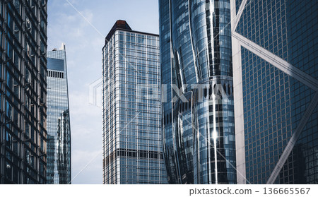 Modern city architecture skyscraper glass facade reflection urban office building exterior detail futuristic design geometric pattern business finance background Modern city architecture skyscraper glass facade reflection urban office building exterior detail futuristic design geometric pattern business finance background 136665567