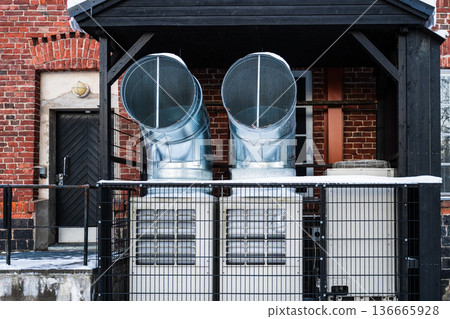 Industrial ventilation system with air ducts and heat pumps on brick building exterior Industrial ventilation system with air ducts and heat pumps on brick building exterior 136665928
