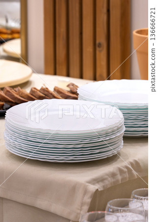 Many white different plates stacked together Many white different plates stacked together 136666721