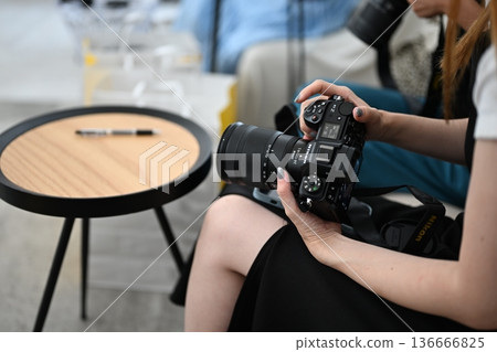 A woman to take with a camera A woman to take with a camera 136666825
