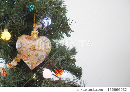 Heart decorations on a Christmas tree Heart decorations on a Christmas tree 136666982