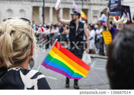 Rainbow flag waving in the crowd at London Pride festival Rainbow flag waving in the crowd at London Pride festival 136667014