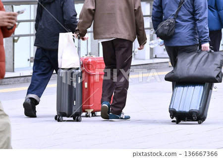Yokohama cityscape in Japan: Suitcases and people walking while using their smartphones... = Shin-Yokohama Station Yokohama cityscape in Japan: Suitcases and people walking while using their smartphones... = Shin-Yokohama Station 136667366