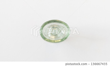 Glass eye wash cup isolated on white background, top view. Vintage eye wash cup made of transparent glass Glass eye wash cup isolated on white background, top view. Vintage eye wash cup made of transparent glass 136667435