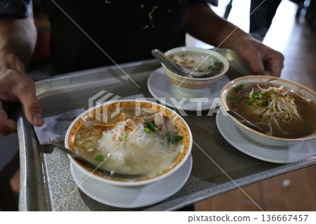 A waiter serving Indonesian food A waiter serving Indonesian food 136667457