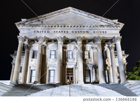 United States Custom House in Charleston, South Carolina. Historic Neoclassical building features massive Corinthian columns and steps illuminated at night 136668198