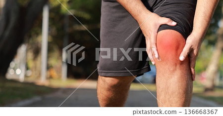 Overweight man suffering from knee pain while jogging in park. Concept of sport injury, joint inflammation, arthritis, healthcare problem, tendonitis, and physical therapy for obese people workout. 136668367
