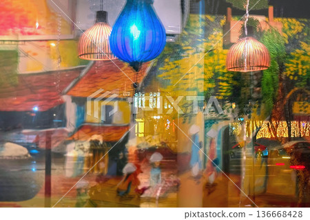 Colorful hanging lamps inside cafe, window reflections of street lights, mural painting on wall, layered urban scene. City lifestyle, cafe interior design, night reflection, creative background Colorful hanging lamps inside cafe, window reflections of street lights, mural painting on wall, layered urban scene. City lifestyle, cafe interior design, night reflection, creative background 136668428