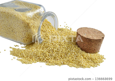 Millet groats in a glass container. Millet groats in a glass container. 136668699
