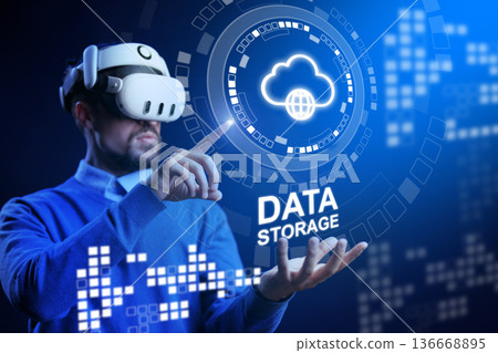 Person uses virtual reality headset to interact with data storage concept in digital space Person uses virtual reality headset to interact with data storage concept in digital space 136668895