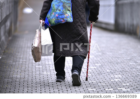 Yokohama cityscape in Japan: Downhill... After the stairs comes a steep downhill... Aging society: Elderly woman with a cane = Yokohama city Yokohama cityscape in Japan: Downhill... After the stairs comes a steep downhill... Aging society: Elderly woman with a cane = Yokohama city 136669389