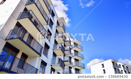 Residential building. bottom view. Modern apartment building on a sunny day. Facade of a modern apartment building. Residential building. bottom view. Modern apartment building on a sunny day. Facade of a modern apartment building. 136669430