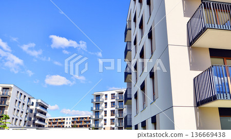 Residential building. bottom view. Modern apartment building on a sunny day. Facade of a modern apartment building. Residential building. bottom view. Modern apartment building on a sunny day. Facade of a modern apartment building. 136669438