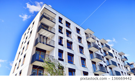 Residential building. bottom view. Modern apartment building on a sunny day. Facade of a modern apartment building. Residential building. bottom view. Modern apartment building on a sunny day. Facade of a modern apartment building. 136669442