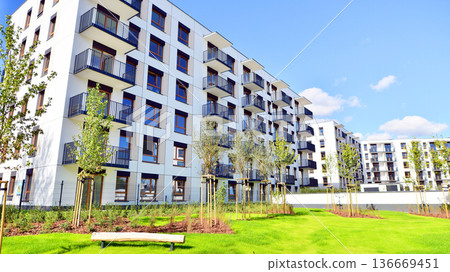 Residential building. bottom view. Modern apartment building on a sunny day. Facade of a modern apartment building. Residential building. bottom view. Modern apartment building on a sunny day. Facade of a modern apartment building. 136669451