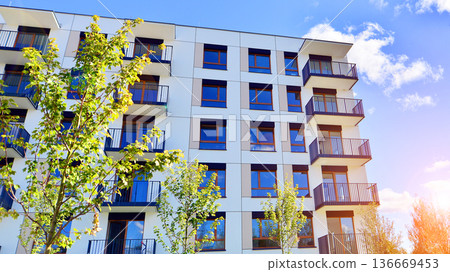 Residential building. bottom view. Modern apartment building on a sunny day. Facade of a modern apartment building. Residential building. bottom view. Modern apartment building on a sunny day. Facade of a modern apartment building. 136669453