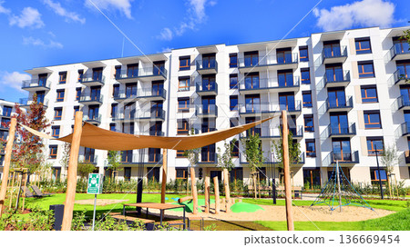 Residential building. bottom view. Modern apartment building on a sunny day. Facade of a modern apartment building. Residential building. bottom view. Modern apartment building on a sunny day. Facade of a modern apartment building. 136669454