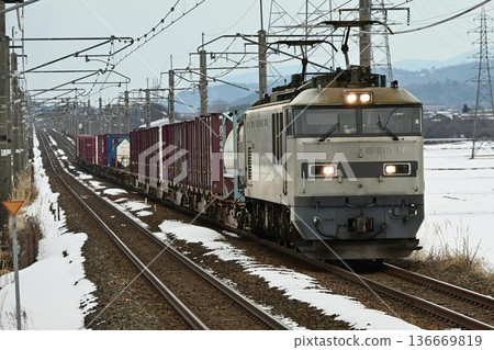A freight train passing through Omi-Nakasho Station on the Kosei Line in the dead of winter 136669819