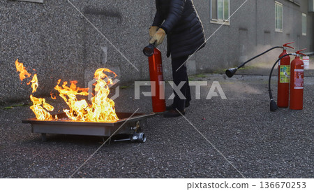 corporate safety - exercise during a firefighting course 136670253