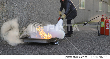 corporate safety - exercise during a firefighting course 136670256