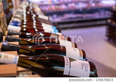 Wine bottles displayed on a shelf in a shop featuring various brands and vintages Wine bottles displayed on a shelf in a shop featuring various brands and vintages 136670623