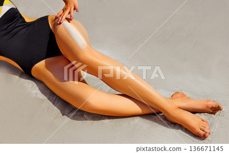 Woman with long legs on sand Woman with long legs on sand 136671145