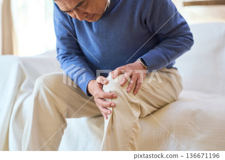 一位年長的亞洲男子摀著疼痛的膝蓋 136671196