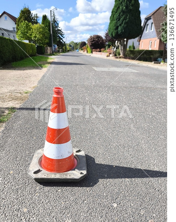 A traffic cone on an empty road A traffic cone on an empty road 136671495