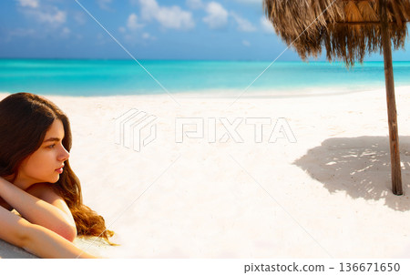 Portrait of gorgeous young woman  while relaxing on beach 136671650