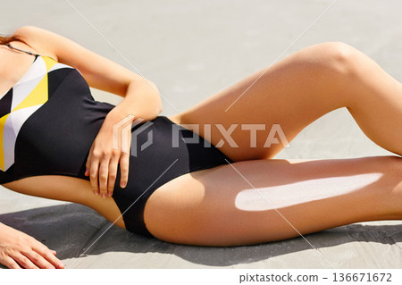 Woman apply sun protection cream on her smooth tanned legs Woman apply sun protection cream on her smooth tanned legs 136671672