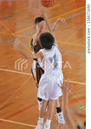 Players playing basketball in the gym 136671690