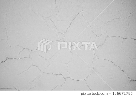 Aged light beige wall with multiple cracks. Damaged surface texture detail for renovation concept. Rough concrete plaster background. Aged light beige wall with multiple cracks. Damaged surface texture detail for renovation concept. Rough concrete plaster background. 136671795