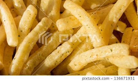 French fries in a wooden bowl on wooden background, top view 136671931