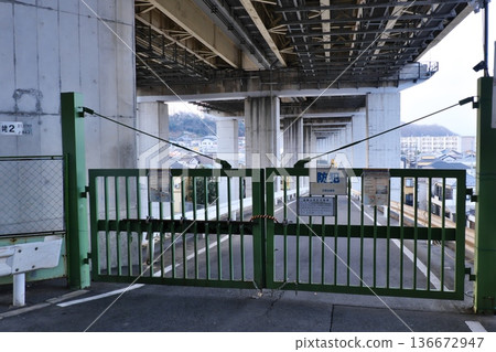 巨大的高架橋下方冷冰冰的空間和緊閉的安全大門 巨大的高架橋下方冷冰冰的空間和緊閉的安全大門 136672947