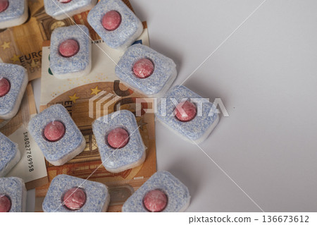 Cleaning supply expense: dishwasher tablets placed directly on euro banknotes 136673612