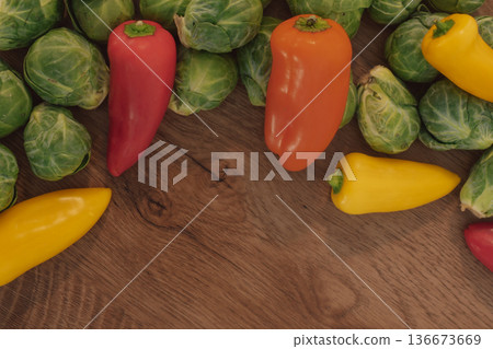 Top view of assorted fresh vegetables forming a border with copy space 136673669