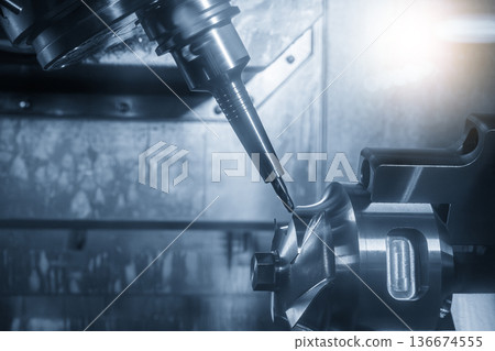 Multi Axis CNC Milling of Automotive Part with Ball Nose End Mill in Blue Industrial Lighting Multi Axis CNC Milling of Automotive Part with Ball Nose End Mill in Blue Industrial Lighting 136674555
