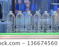 PET Drinking Water Bottles on Conveyor Belt. 136674560