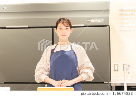 A young female store clerk providing guidance in front of the cash register A young female store clerk providing guidance in front of the cash register 136674828