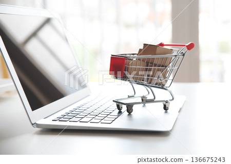 Internet shopping concept. Trolley on laptop Internet shopping concept. Trolley on laptop 136675243