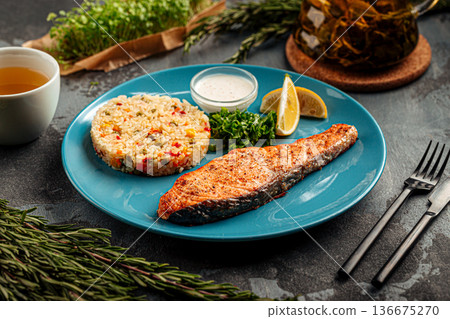 Salmon steak with rice and lemon Salmon steak with rice and lemon 136675270