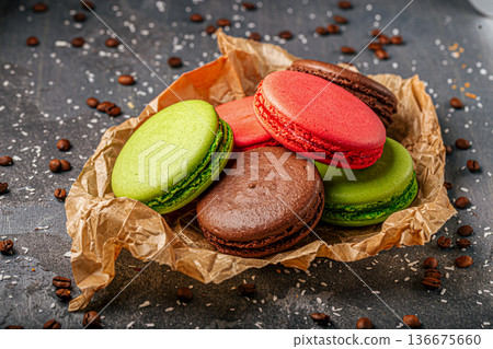 Colorful macarons on paper with coffee beans 136675660