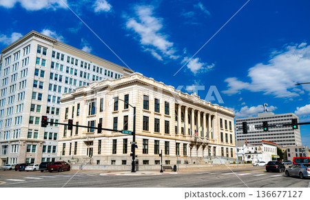 Memorial Hall in Topeka, Kansas. Historic Neoclassical government architecture features a grand limestone facade with Corinthian columns under a bright blue sky 136677127