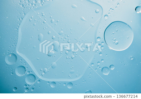 Close up view of water and oil creating an abstract blue texture Close up view of water and oil creating an abstract blue texture 136677214