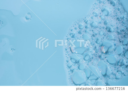 Blue liquid with transparent soap foam texture and abstract bubbles Blue liquid with transparent soap foam texture and abstract bubbles 136677216