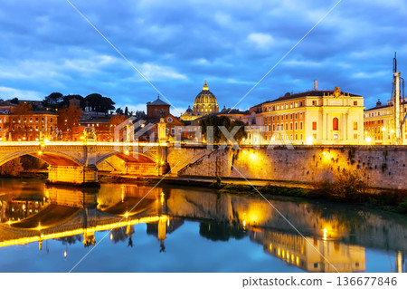 Image of St. Peter's Basilica, Ponte Sant Angelo and Tiber River at dark night in Rome, Italy. Sant' Angelo Bridge and St. Peter's cathedral at sunset in Vatican City, Rome, Italy. 136677846