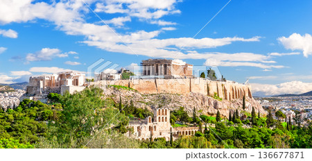 The Acropolis of Athens with the Parthenon Temple in sunny day, Greece. View of the ruins of the ancient city of Athens in Greece. The Acropolis of Athens with the Parthenon Temple in sunny day, Greece. View of the ruins of the ancient city of Athens in Greece. 136677871